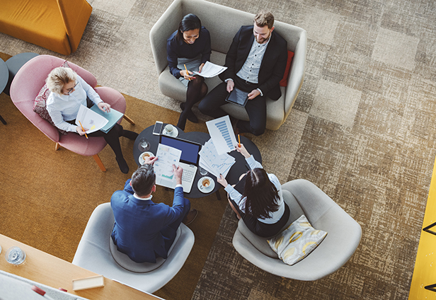 Arial view of employees sitting in chairs working