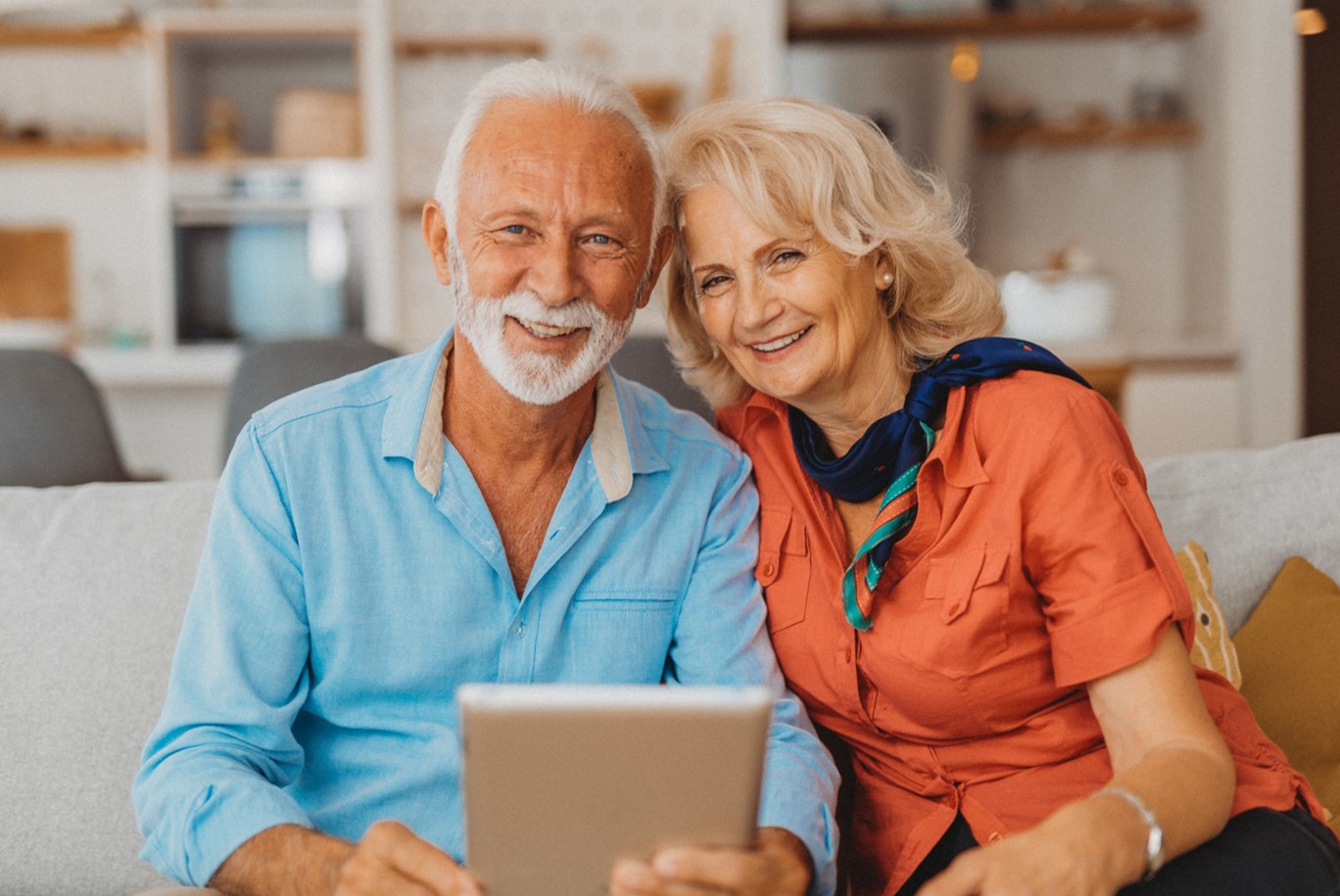 Older couple holding a tablet tablet