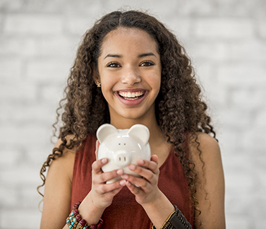 girl holding a piggy bank image